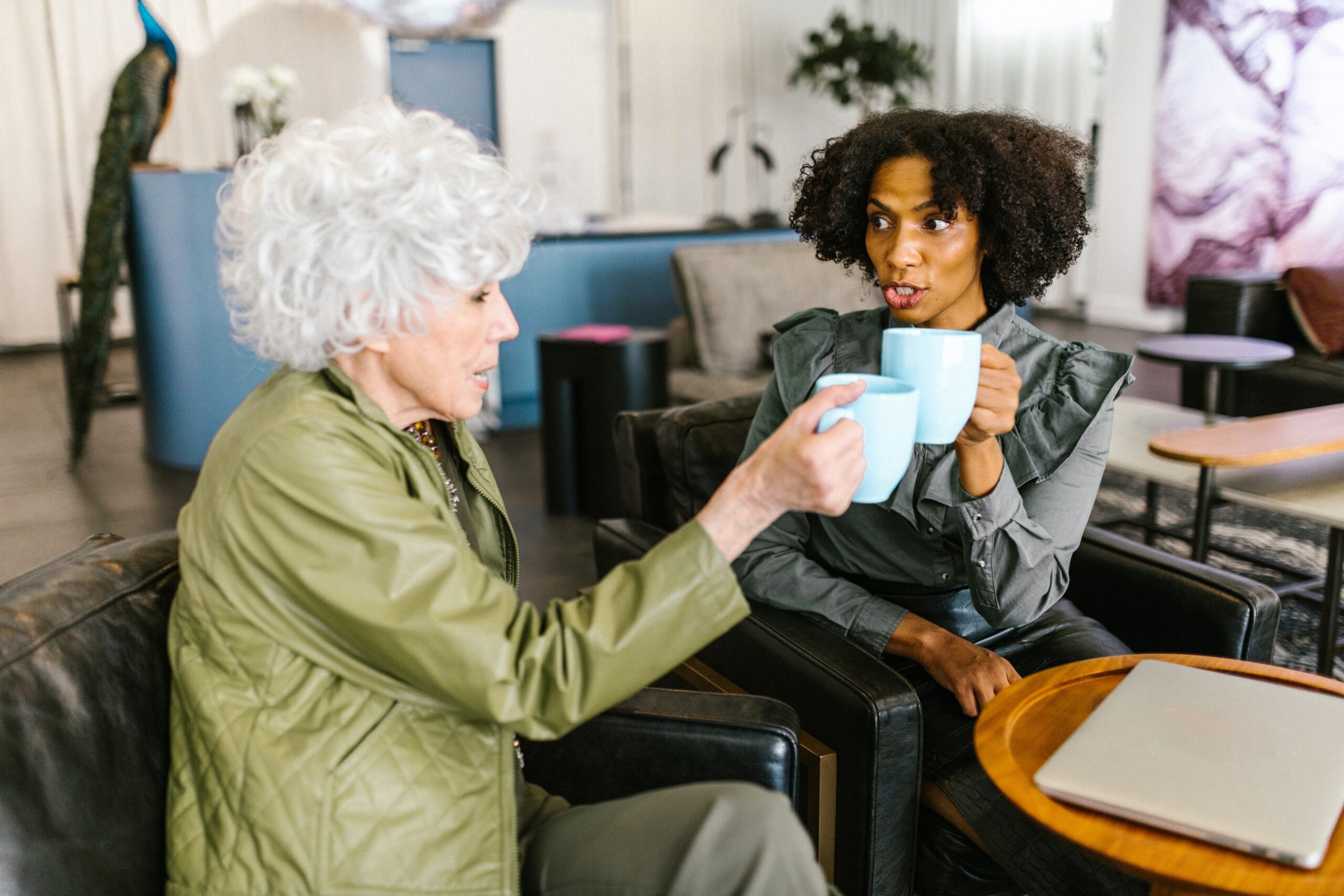 Two women engaging in conversation over tea, exemplifying the power of storytelling in boosting engagement.