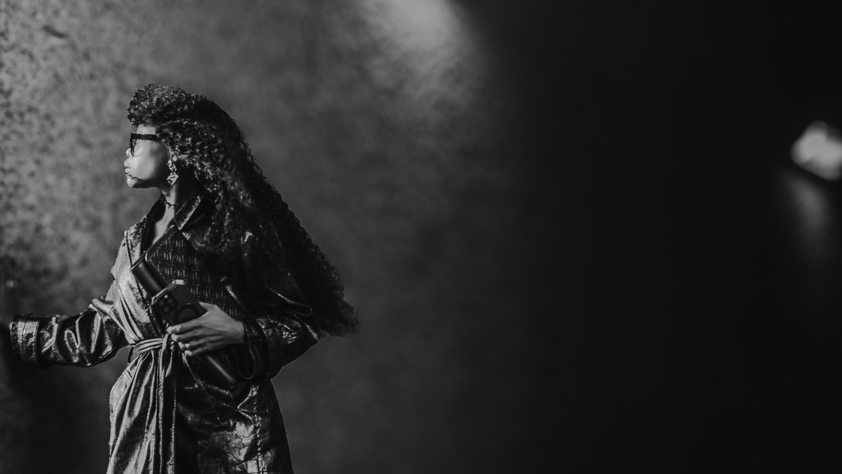 Bess Obarotimi standing in soft light, symbolising reflection and the inner journey of shadow work and self-growth.