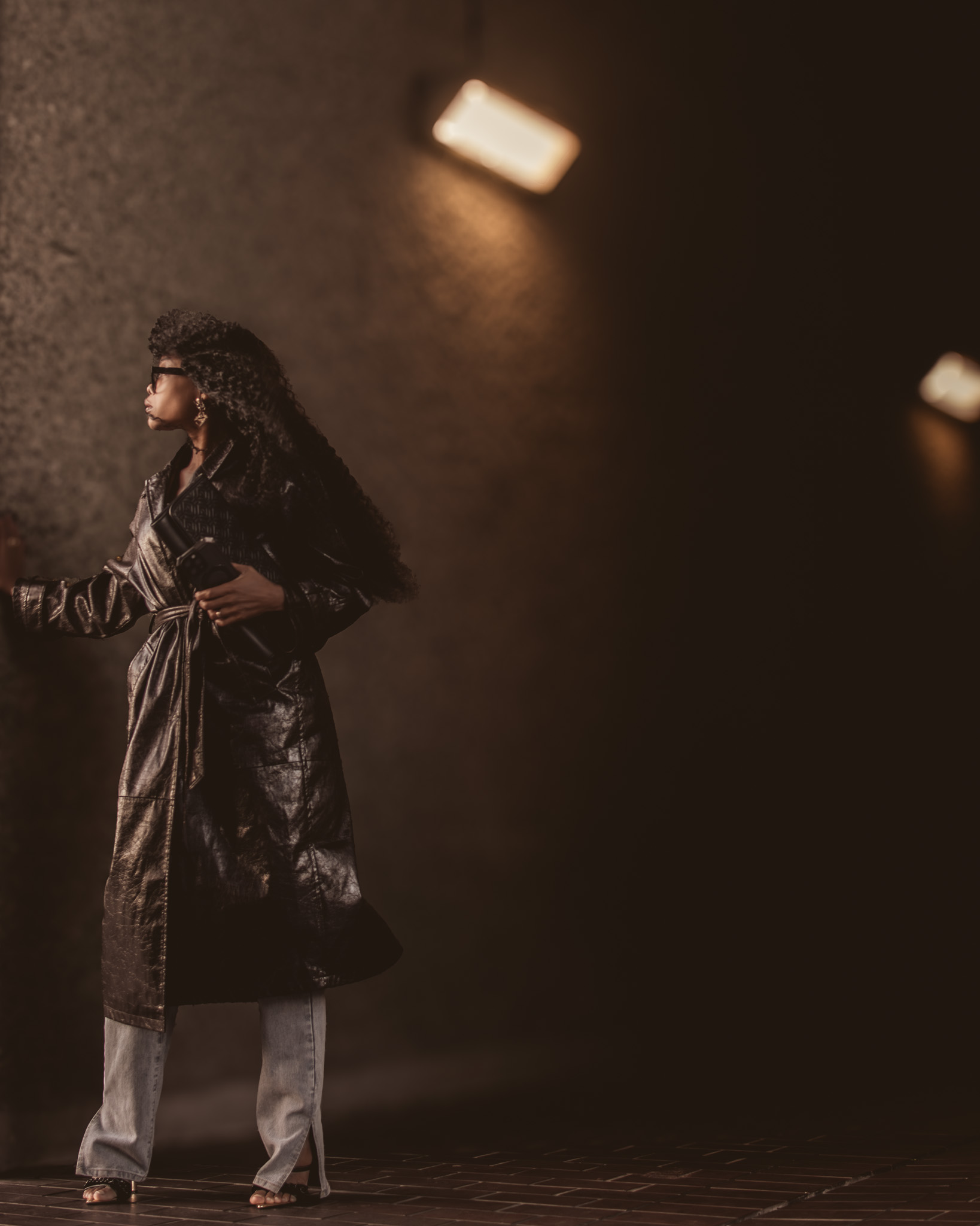 Vertical portrait of Bess Obarotimi in reflective light, representing the courage and calm that comes through shadow work.