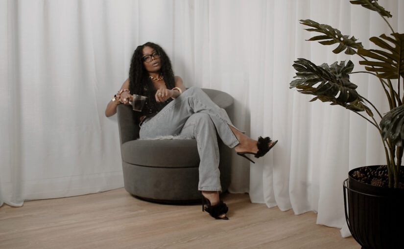 Bess Obarotimi seated in a calm, minimalist space, speaking on why presence is the new productivity during the I AM Success Mini-Series