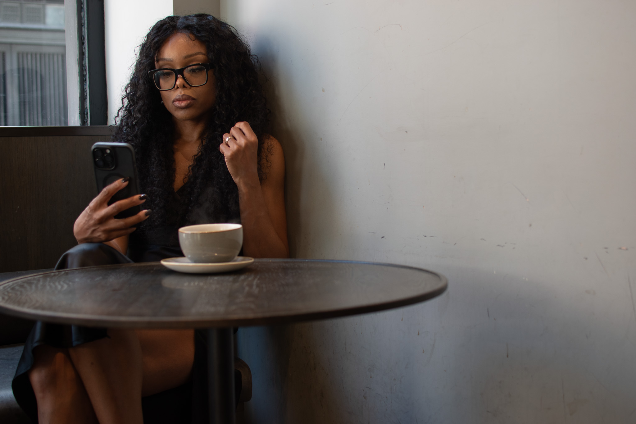 Senior leader reflecting on the leadership coherence problem while reviewing strategy on a phone