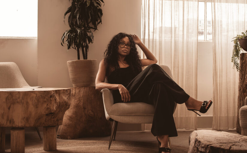 Portrait of a woman seated in a modern office, representing leadership decision making and executive authority.
