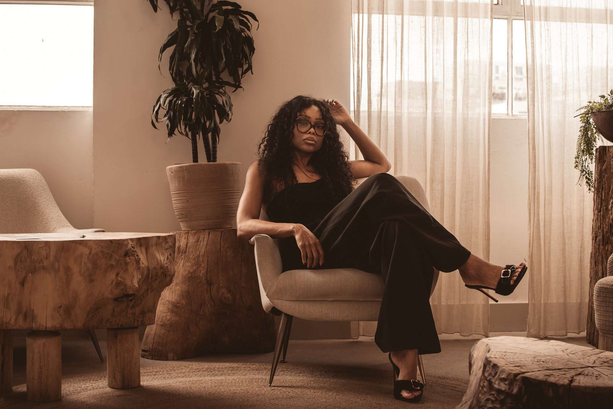 Portrait of a woman seated in a modern office, representing leadership decision making and executive authority.