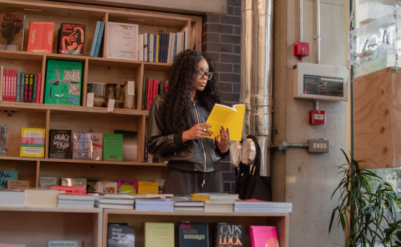 AI governance collaboration in organisations, professional reviewing documents in a bookstore setting